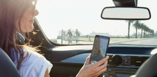 Woman using Cygnett MagMount Qi Wireless Car Charger to charge phone