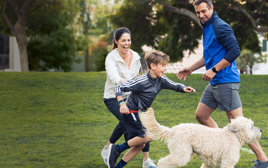 Family playing while wearing Fitbits