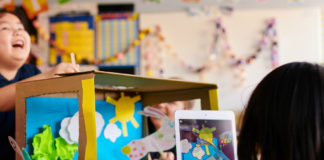 Child using iPad in classroom