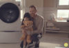 Father and daughter hugging in front of LG Steam Washer