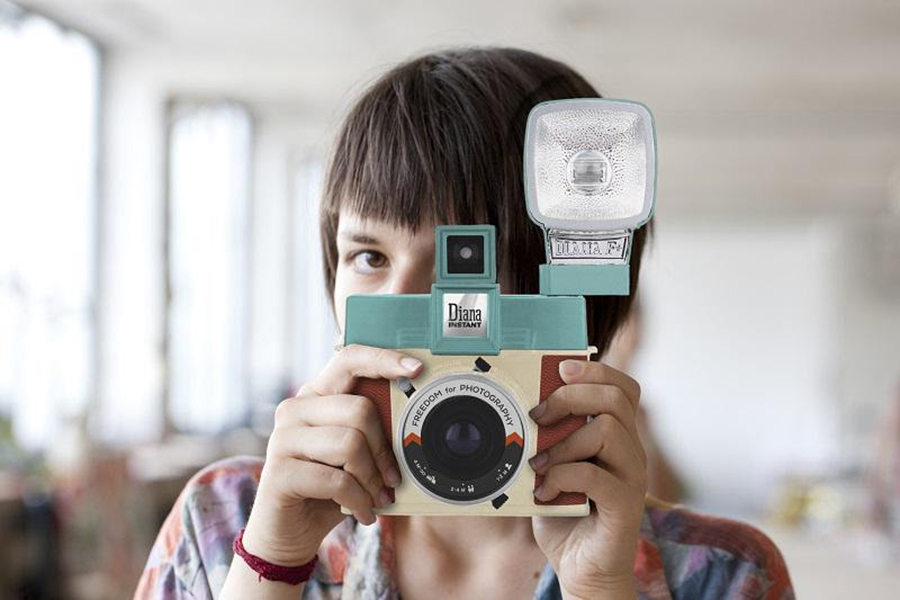 Woman holding the Diana Instant Square