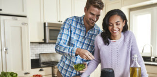 Man and woman with JBL Link 20 in kitchen