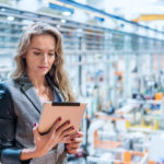 Woman working in factory & using tablet