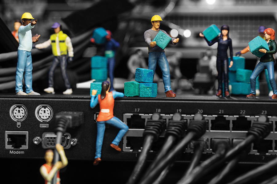 Miniature figures working at a data centre run with DCIM