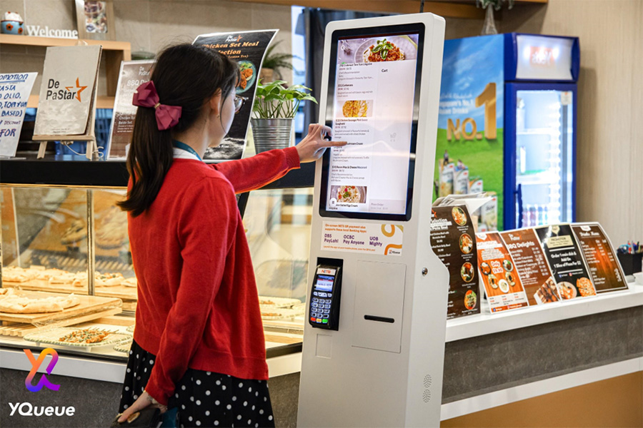 Woman using YQueue point-of-sale
